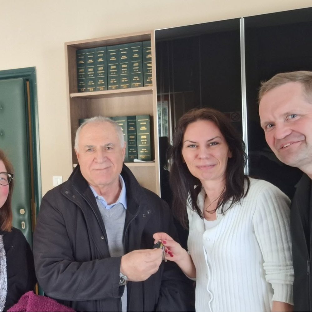 A young Polish couple receiving the keys to their new Sicilian home at the notary