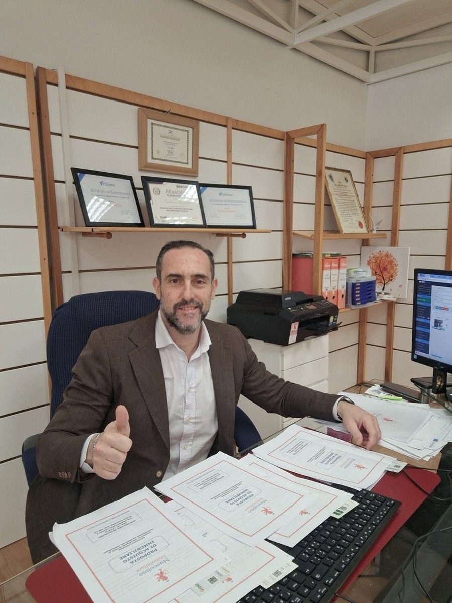 Manfredi Muscolino in his Sicily office, with professional certificates on the wall